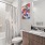 bathroom with sink large mirror toiler and shower