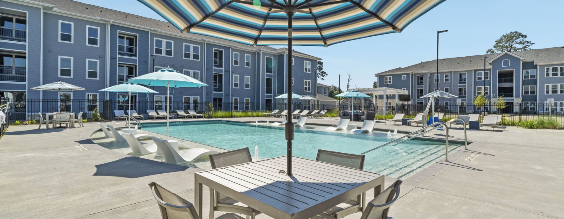 Resort-style swimming pool with lounge seating