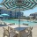 seating area with umbrella by a pool
