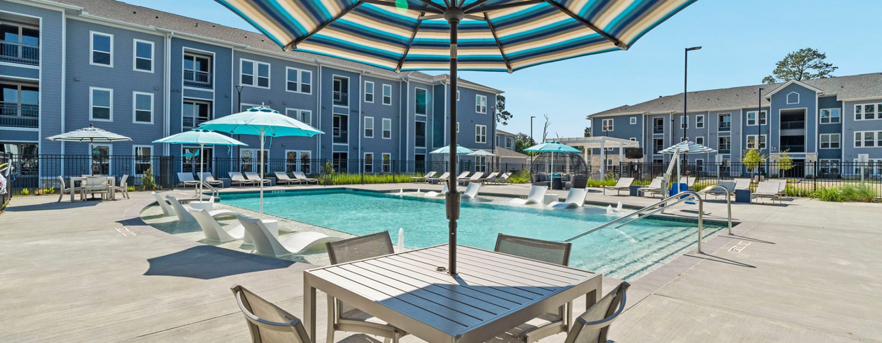 seating area with umbrella by a pool